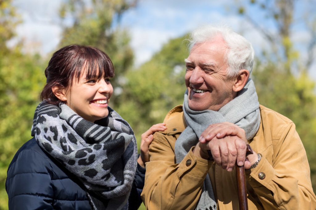 Two people laughing in the park